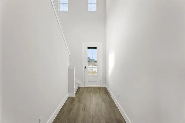 a view of a hallway with wooden floor