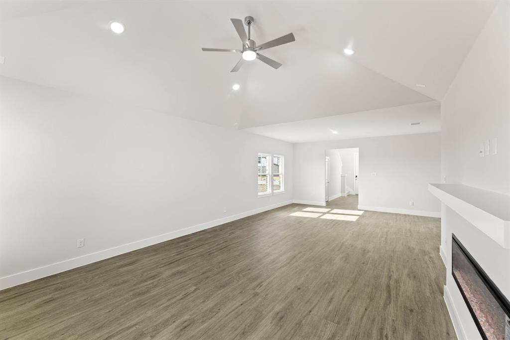 1504 Blackthorne Lane Krum, TX 76249 - Photo 6 of 30 an empty room with wooden floor and ceiling fan