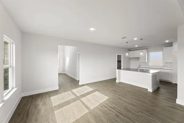 a view of kitchen with wooden floor and windows