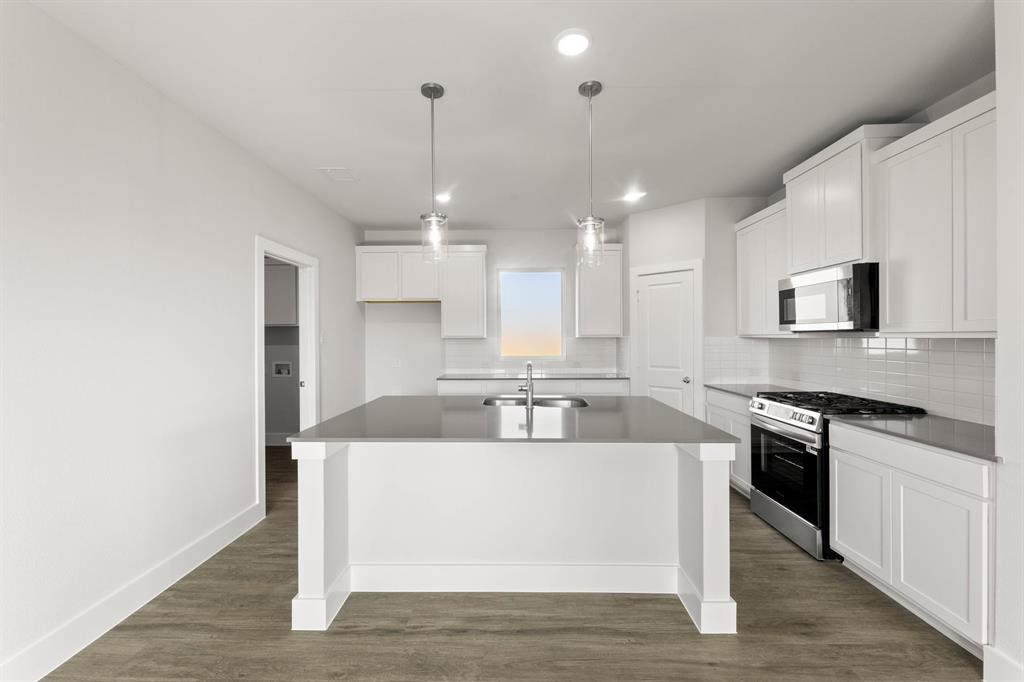 1504 Blackthorne Lane Krum, TX 76249 - Photo 10 of 30 a large kitchen with a center island and stainless steel appliances