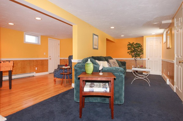 237 Holt Road Andover, MA 01810 - Photo 20 of 27 a living room with furniture a rug and a floor to ceiling window