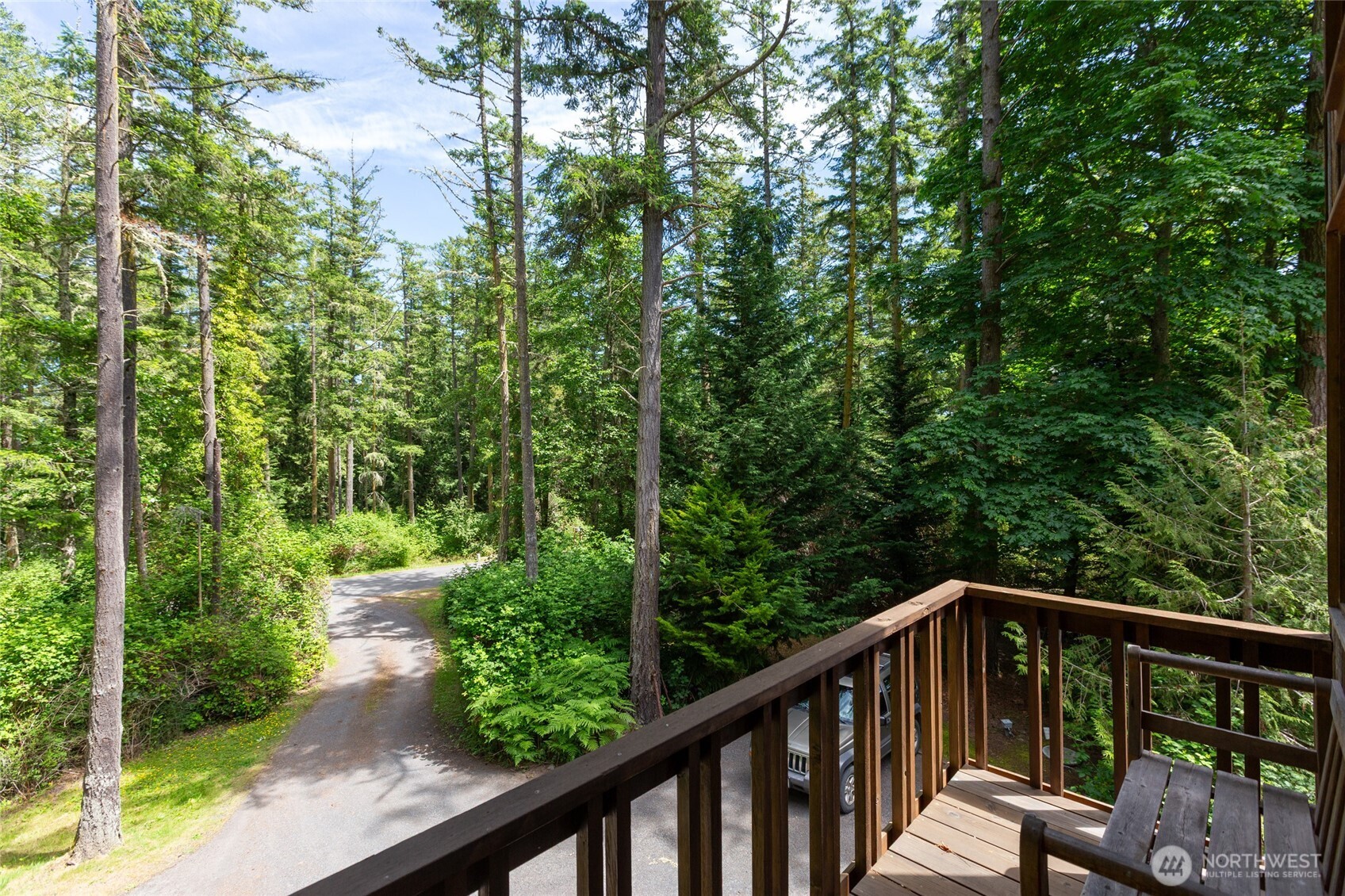 128 White Point Road Friday Harbor, WA 98250 - Photo 13 of 40 a balcony with wooden floor and trees in the back