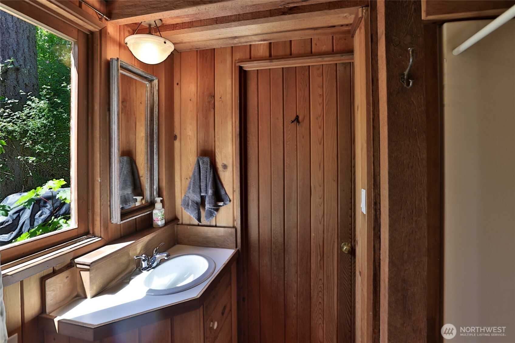 128 White Point Road Friday Harbor, WA 98250 - Photo 15 of 40 a bathroom with a sink a mirror and a window