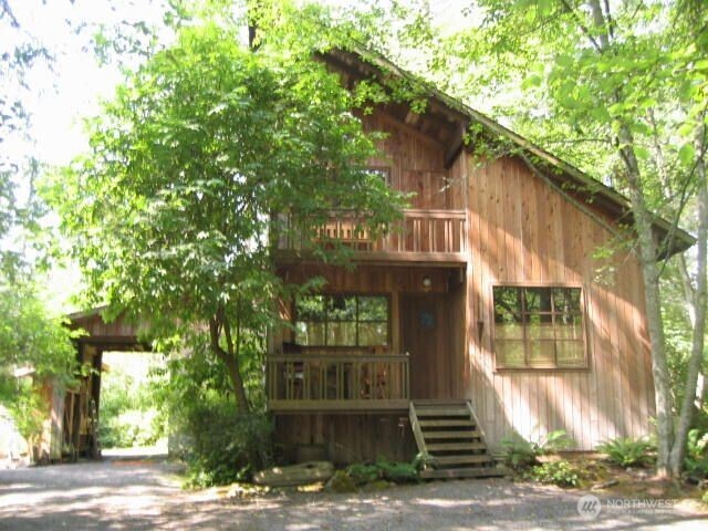 128 White Point Road Friday Harbor, WA 98250 - Photo 2 of 40 a front view of a house with a tree