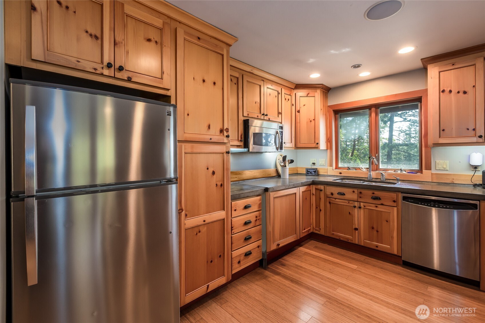 128 White Point Road Friday Harbor, WA 98250 - Photo 26 of 40 a kitchen with stainless steel appliances granite countertop a refrigerator a sink dishwasher a stove and white countertops with wooden floor