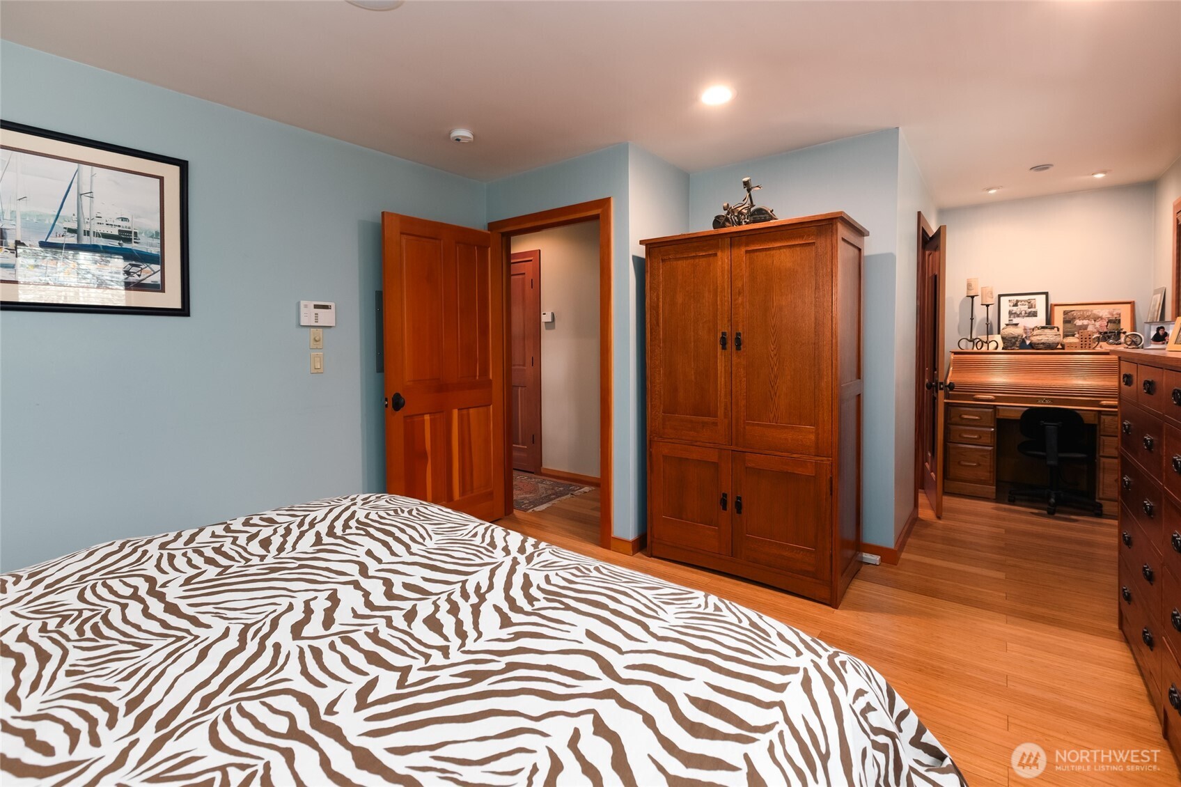 128 White Point Road Friday Harbor, WA 98250 - Photo 29 of 40 a bedroom with a large bed and a chandelier