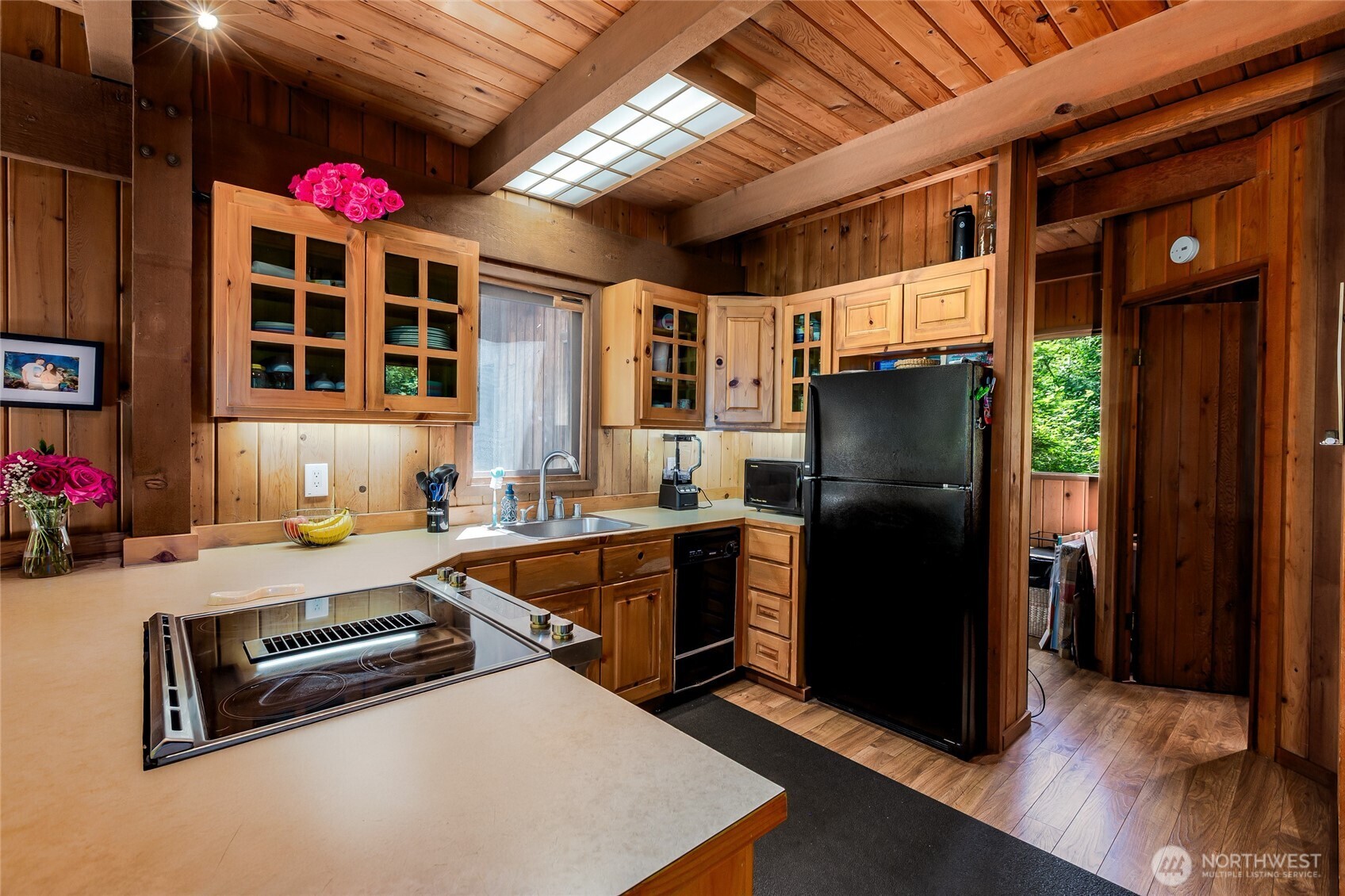 128 White Point Road Friday Harbor, WA 98250 - Photo 9 of 40 a kitchen with stainless steel appliances granite countertop a refrigerator and wooden cabinets