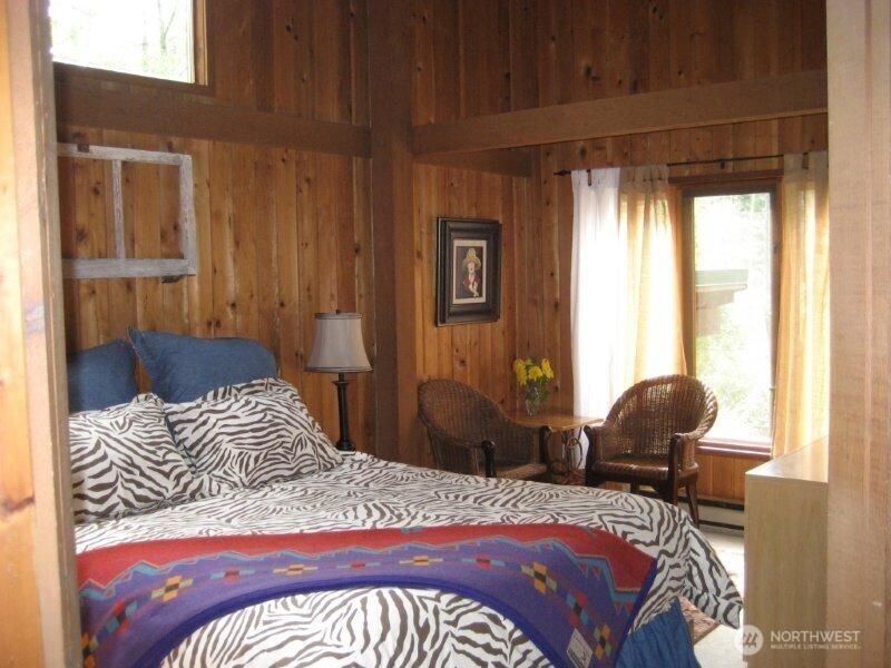 128 White Point Road Friday Harbor, WA 98250 - Photo 10 of 40 a bedroom with a bed and chair