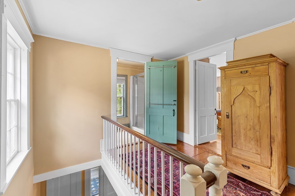913 Salem End Road Framingham, MA 01702 - Photo 24 of 42 a view of a hallway with wooden floor and door