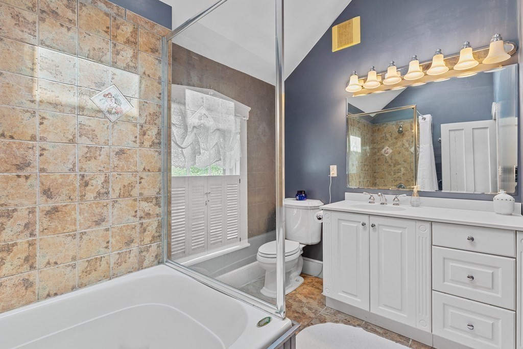 913 Salem End Road Framingham, MA 01702 - Photo 33 of 42 a bathroom with a granite countertop sink a toilet a mirror a vanity and bathtub