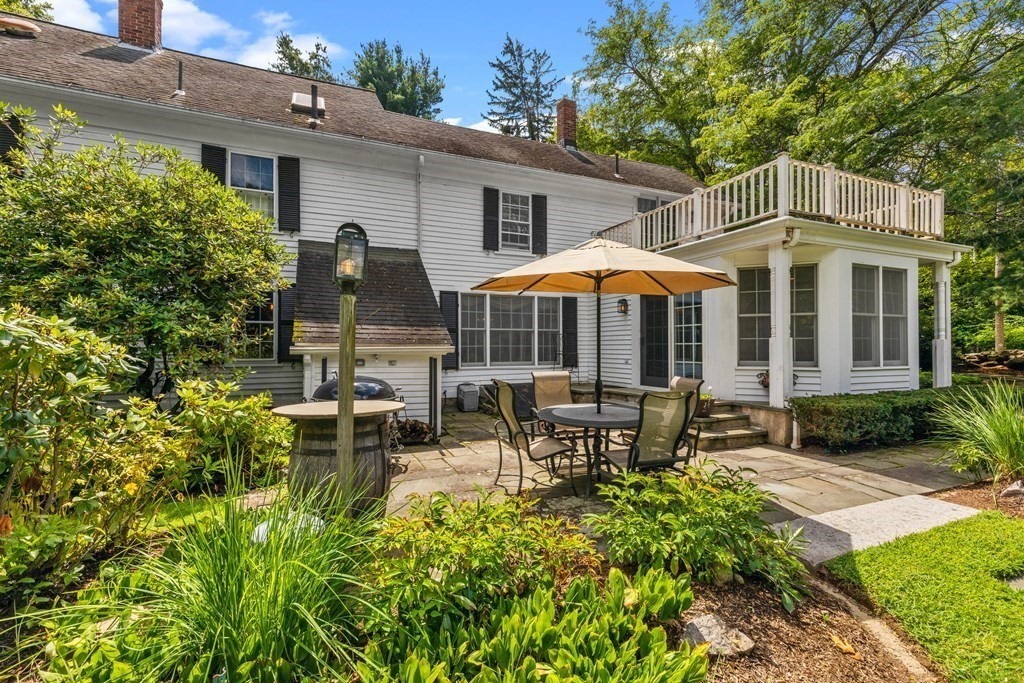 913 Salem End Road Framingham, MA 01702 - Photo 36 of 42 a view of a house with backyard sitting area and garden