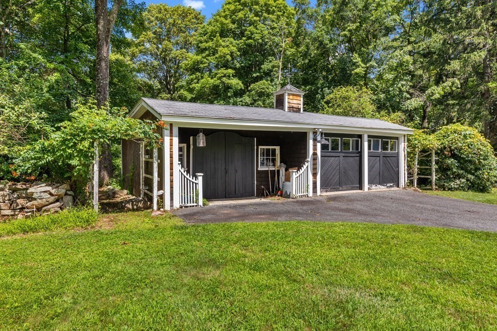 913 Salem End Road Framingham, MA 01702 - Photo 37 of 42 a view of a brick house with a large windows and a large tree