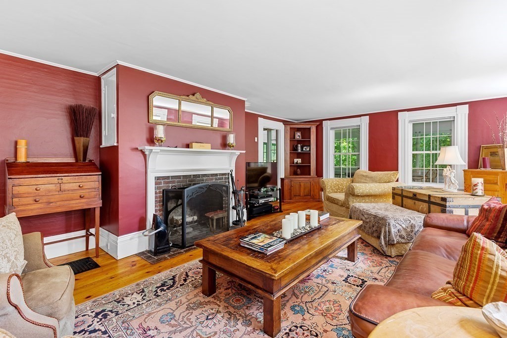 913 Salem End Road Framingham, MA 01702 - Photo 6 of 42 a living room with furniture a flat screen tv and a fireplace