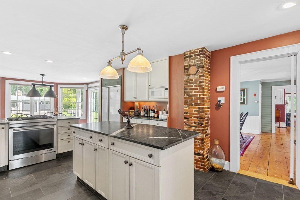 913 Salem End Road Framingham, MA 01702 - Photo 8 of 42 a kitchen with stainless steel appliances granite countertop a sink and a stove