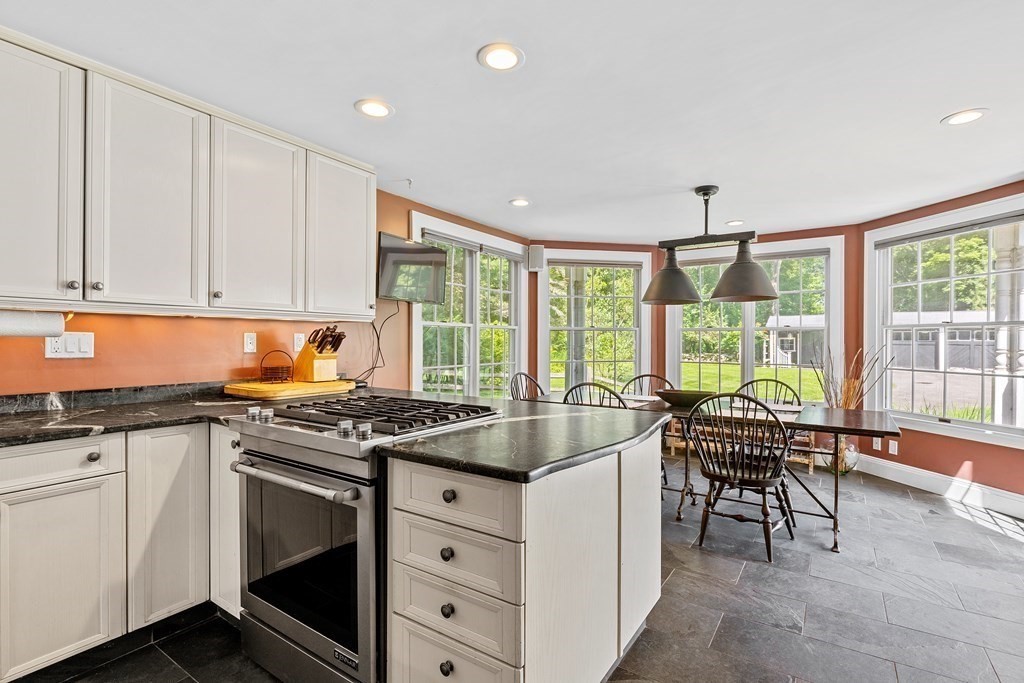 913 Salem End Road Framingham, MA 01702 - Photo 10 of 42 a kitchen with a stove a sink and cabinets