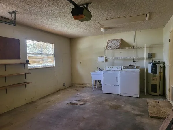 a utility room with cabinets dryer and washer