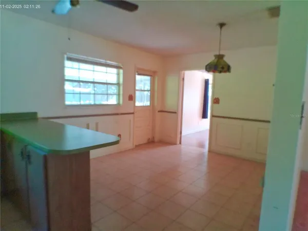 a kitchen with a refrigerator and window