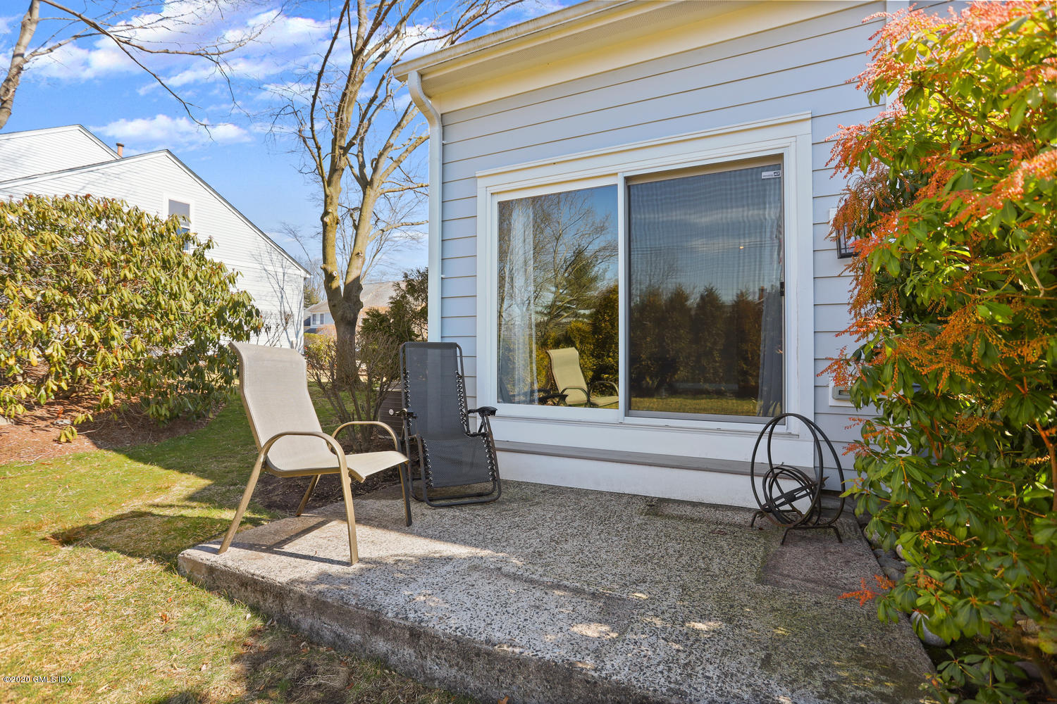 19 Whiffletree Way, Unit 19 Riverside, CT 06878 - Photo 14 of 32 a view of a house with backyard porch and sitting area
