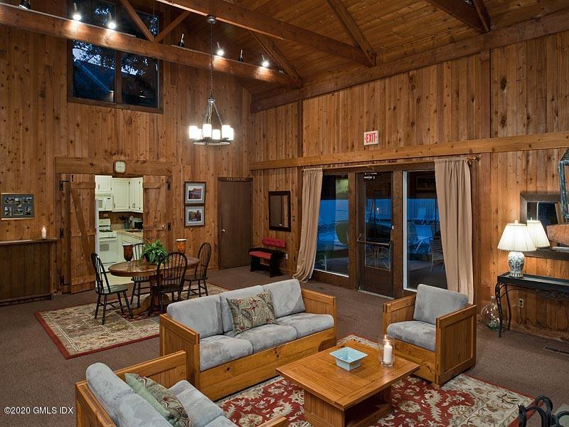 19 Whiffletree Way, Unit 19 Riverside, CT 06878 - Photo 24 of 32 a living room with furniture a lamp and a fireplace