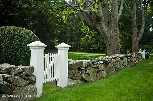 19 Whiffletree Way, Unit 19 Riverside, CT 06878 - Photo 29 of 32 a front view of a house with a yard