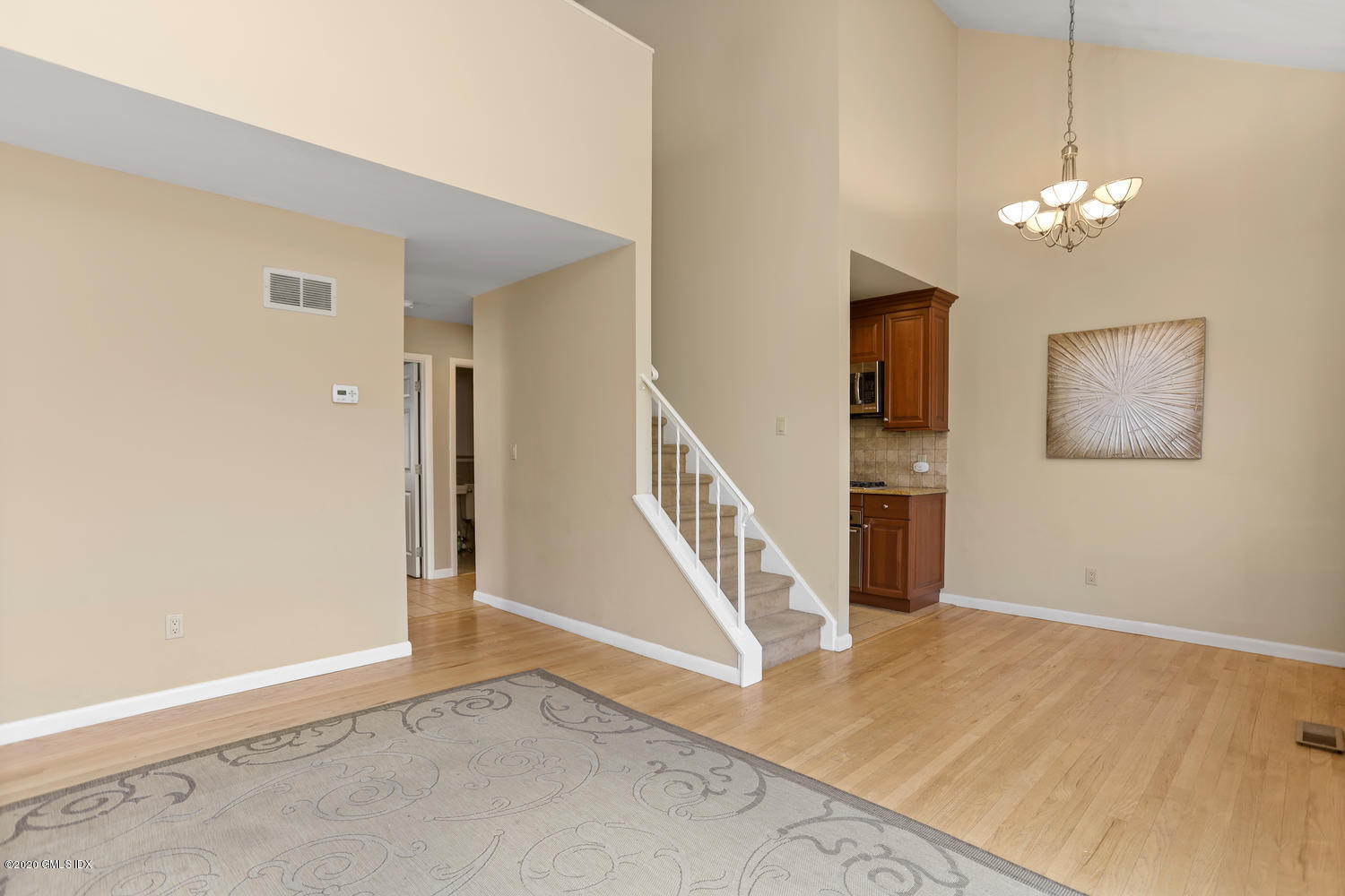 19 Whiffletree Way, Unit 19 Riverside, CT 06878 - Photo 6 of 32 a view of a livingroom with wooden floor and stairs