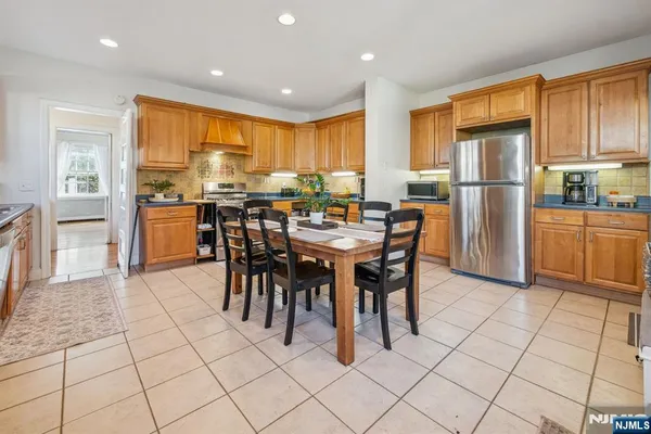 a kitchen with stainless steel appliances granite countertop a refrigerator and a stove top oven