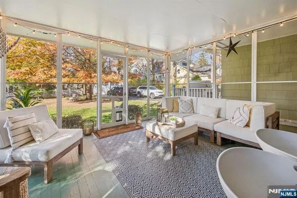 a living room with furniture and a floor to ceiling window