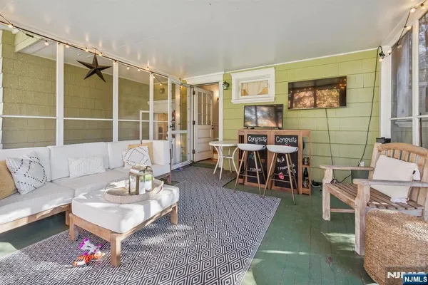 a living room with furniture a rug and a table