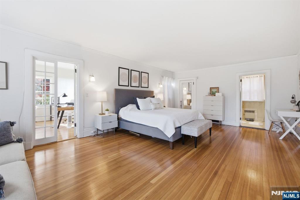258 Ridgewood Avenue Glen Ridge, NJ 07028 - Photo 21 of 44 a spacious bedroom with a bed and wooden floor