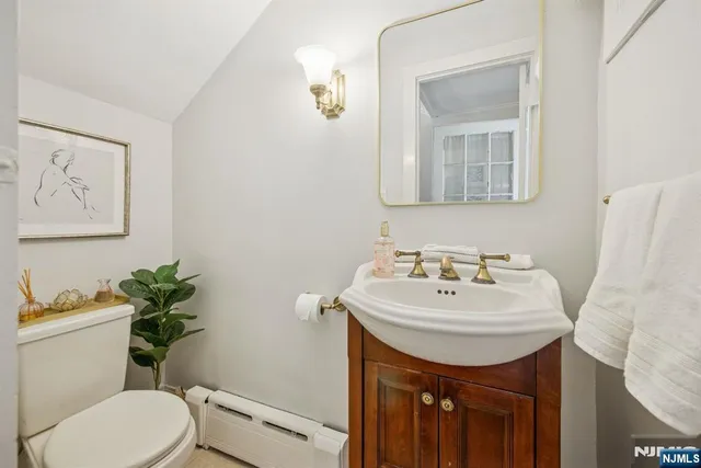 a bathroom with a sink mirror and toilet