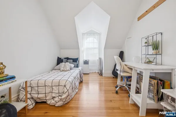 a bedroom with furniture and a wooden floor