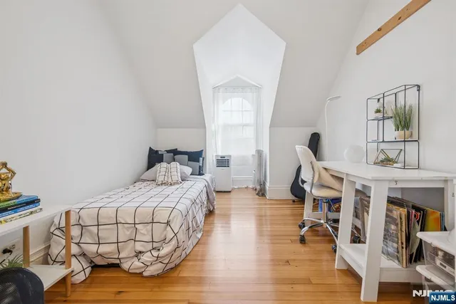 a bedroom with furniture and a wooden floor