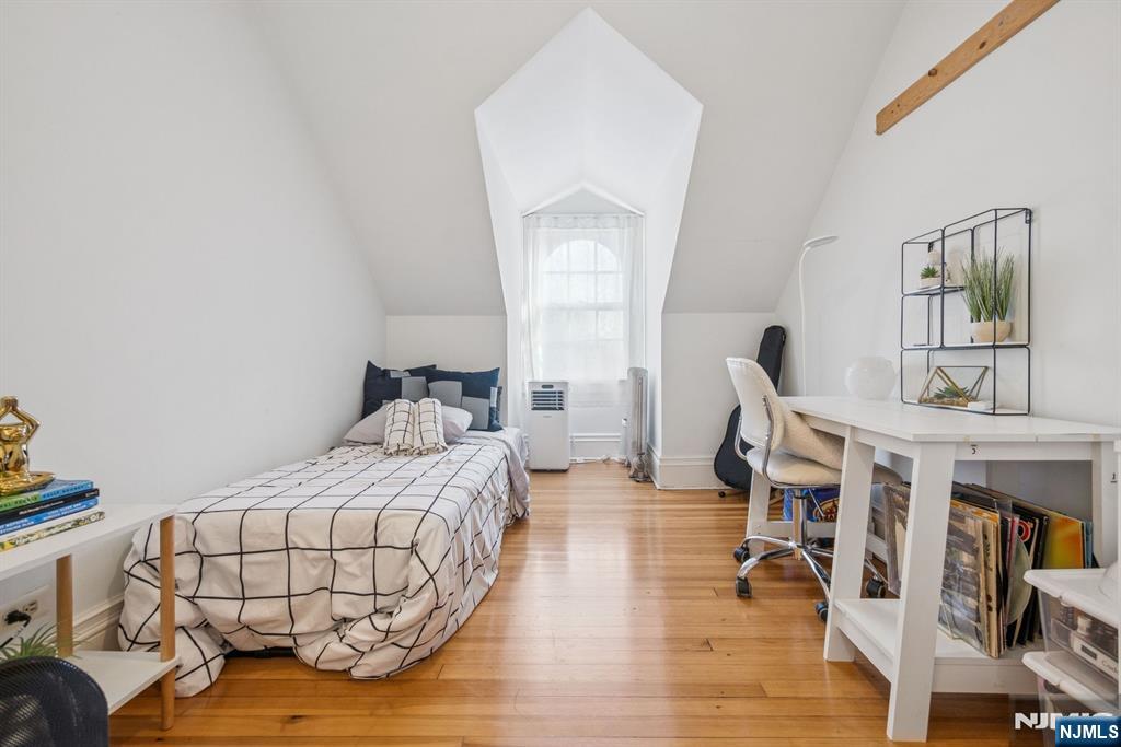 258 Ridgewood Avenue Glen Ridge, NJ 07028 - Photo 28 of 44 a bedroom with furniture and a wooden floor