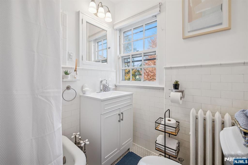 258 Ridgewood Avenue Glen Ridge, NJ 07028 - Photo 30 of 44 a bathroom with a sink toilet and shower