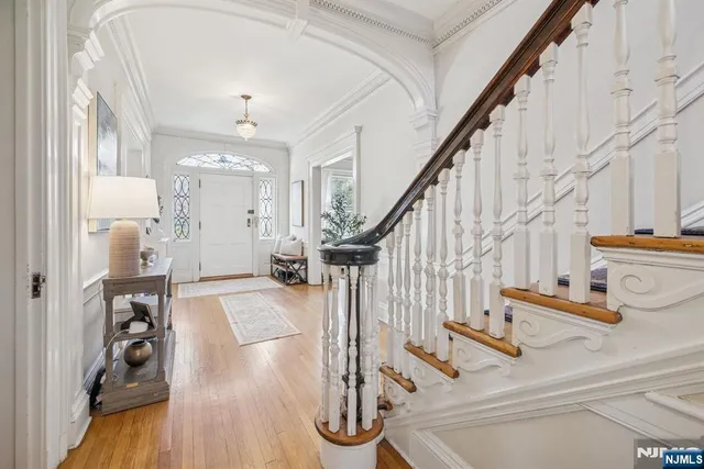 a view of entryway and hall with wooden floor