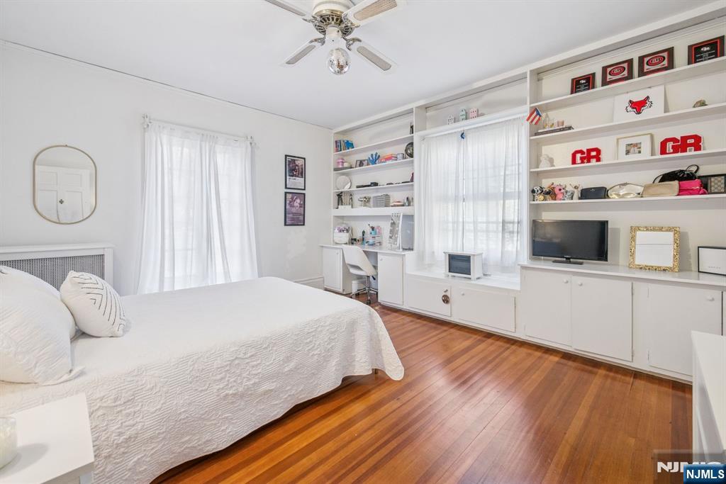 258 Ridgewood Avenue Glen Ridge, NJ 07028 - Photo 31 of 44 a bedroom with a bed and a wooden floor