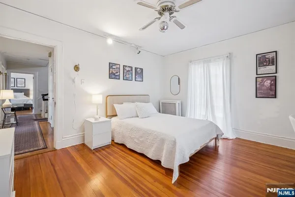 a bedroom with a large bed and a chandelier
