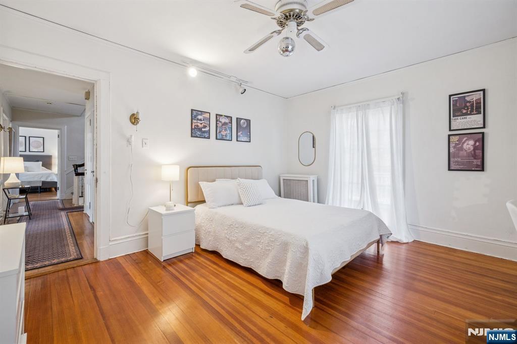 258 Ridgewood Avenue Glen Ridge, NJ 07028 - Photo 32 of 44 a bedroom with a large bed and a chandelier