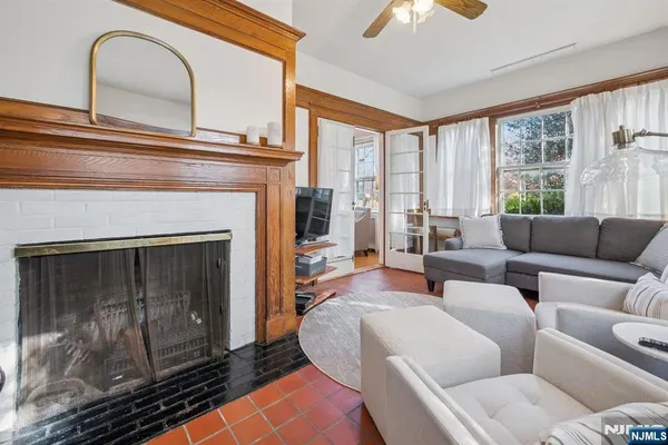 a living room with furniture a large window and a fireplace