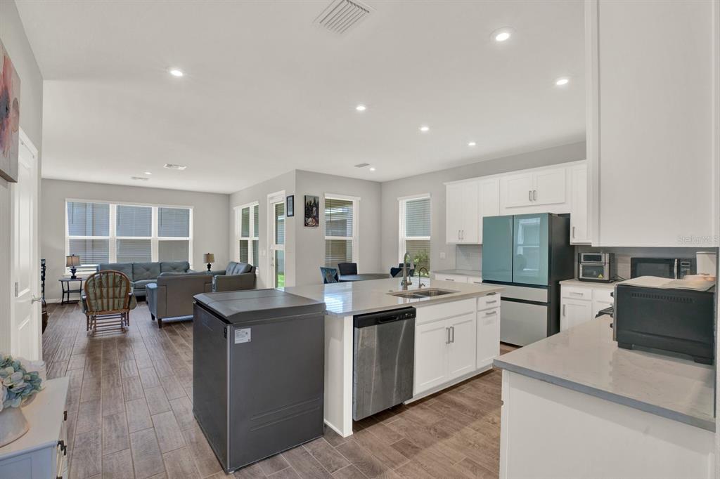 13729 Rangeland Boulevard Odessa, FL 33556 - Photo 8 of 30 a kitchen with lots of counter space and stainless steel appliances