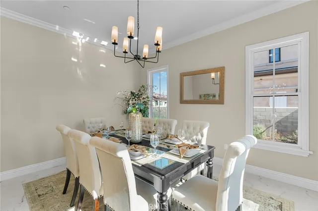 a living room with furniture a chandelier and a table