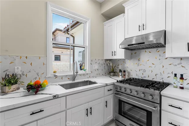 a large kitchen with kitchen island a stove a table and chairs