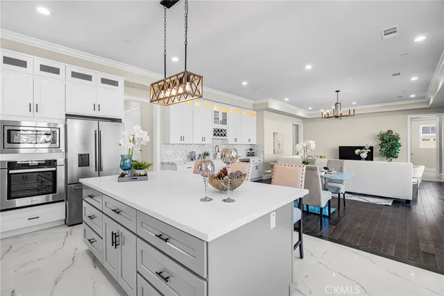 a kitchen with stainless steel appliances a sink a stove and cabinets