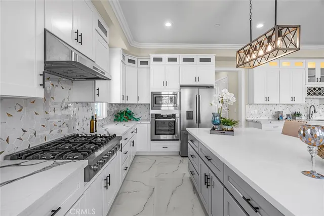 a kitchen with kitchen island granite countertop a sink a center island and cabinets