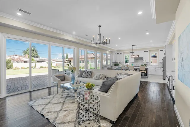 a view of a hallway with wooden floor and windows
