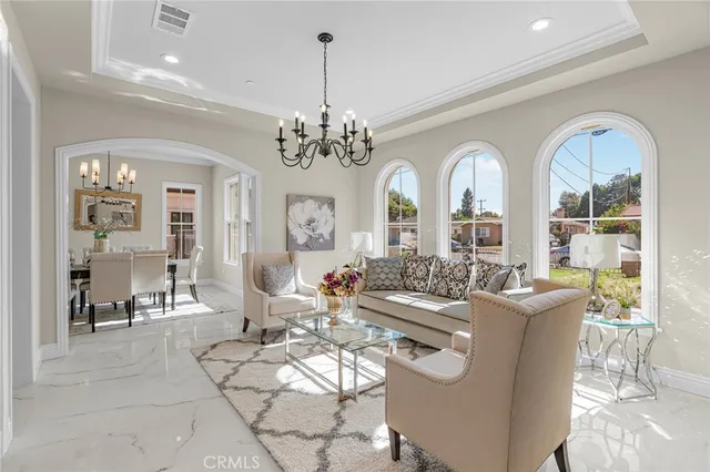 a living room with furniture and a chandelier