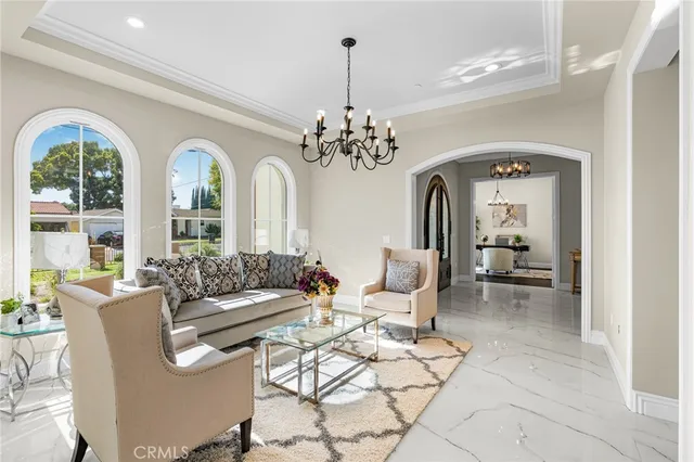 a view of a dining room with furniture and chandelier