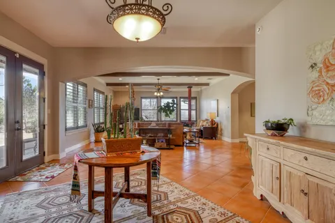 a living room with fireplace furniture and a large window