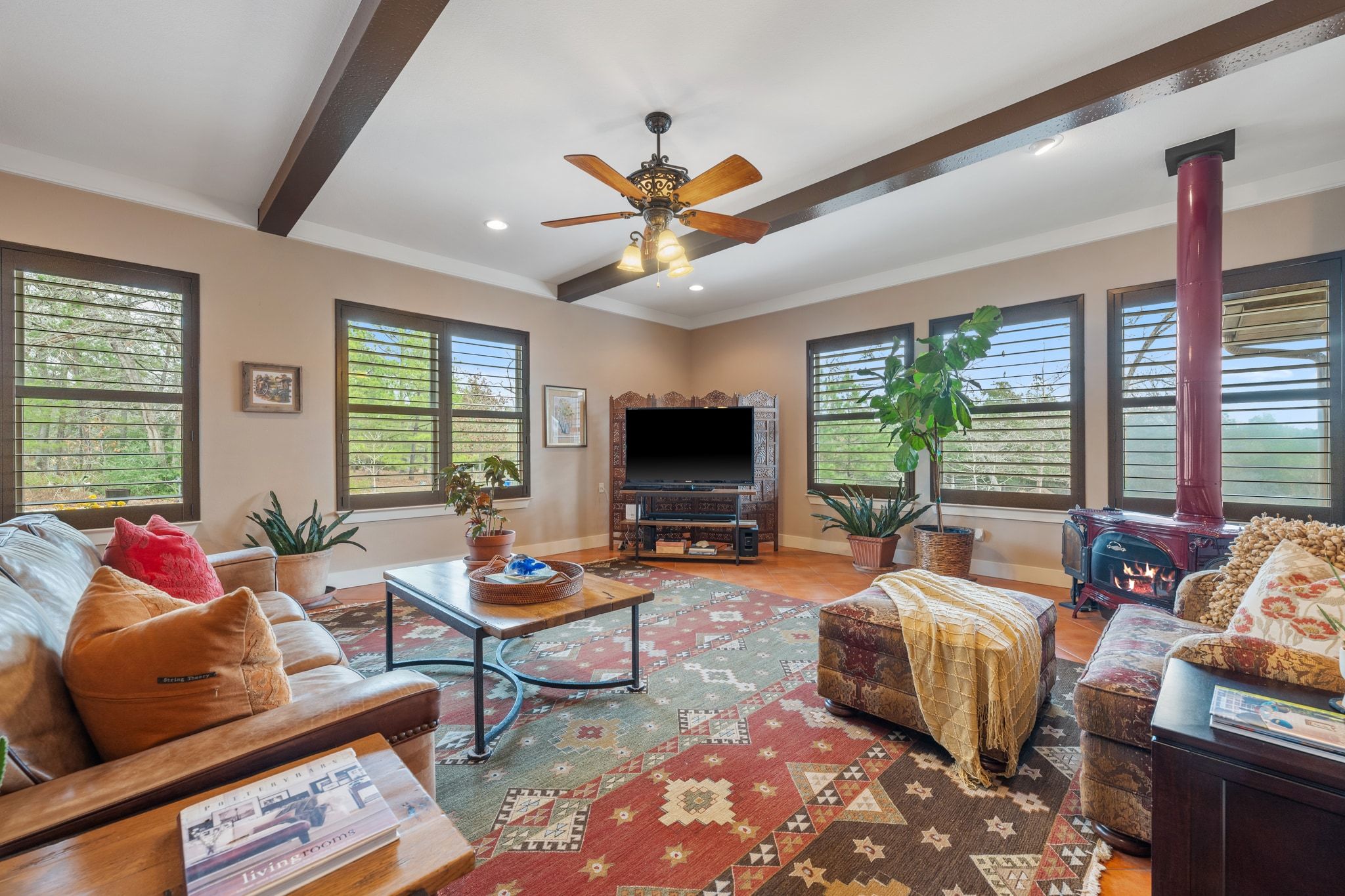 129 Painted Post Bastrop, TX 78602 - Photo 13 of 40 The living room is bright and expansive, wrapped in windows that showcase your private acreage and infuse the home in natural light.