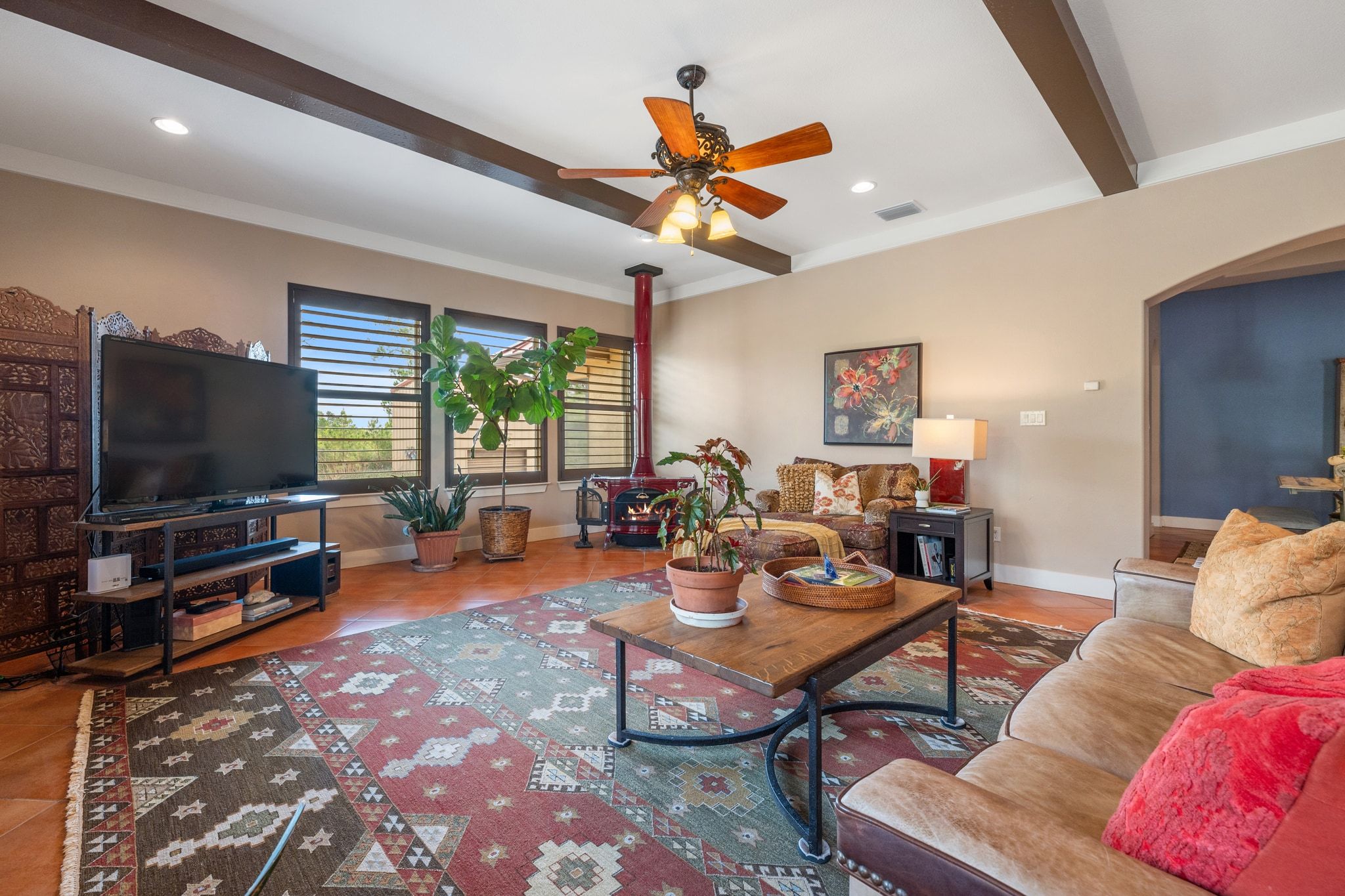 129 Painted Post Bastrop, TX 78602 - Photo 14 of 40 Striking wood beams stretch across the living room, which features a gorgeous wood burning stove for cozy winter evenings.